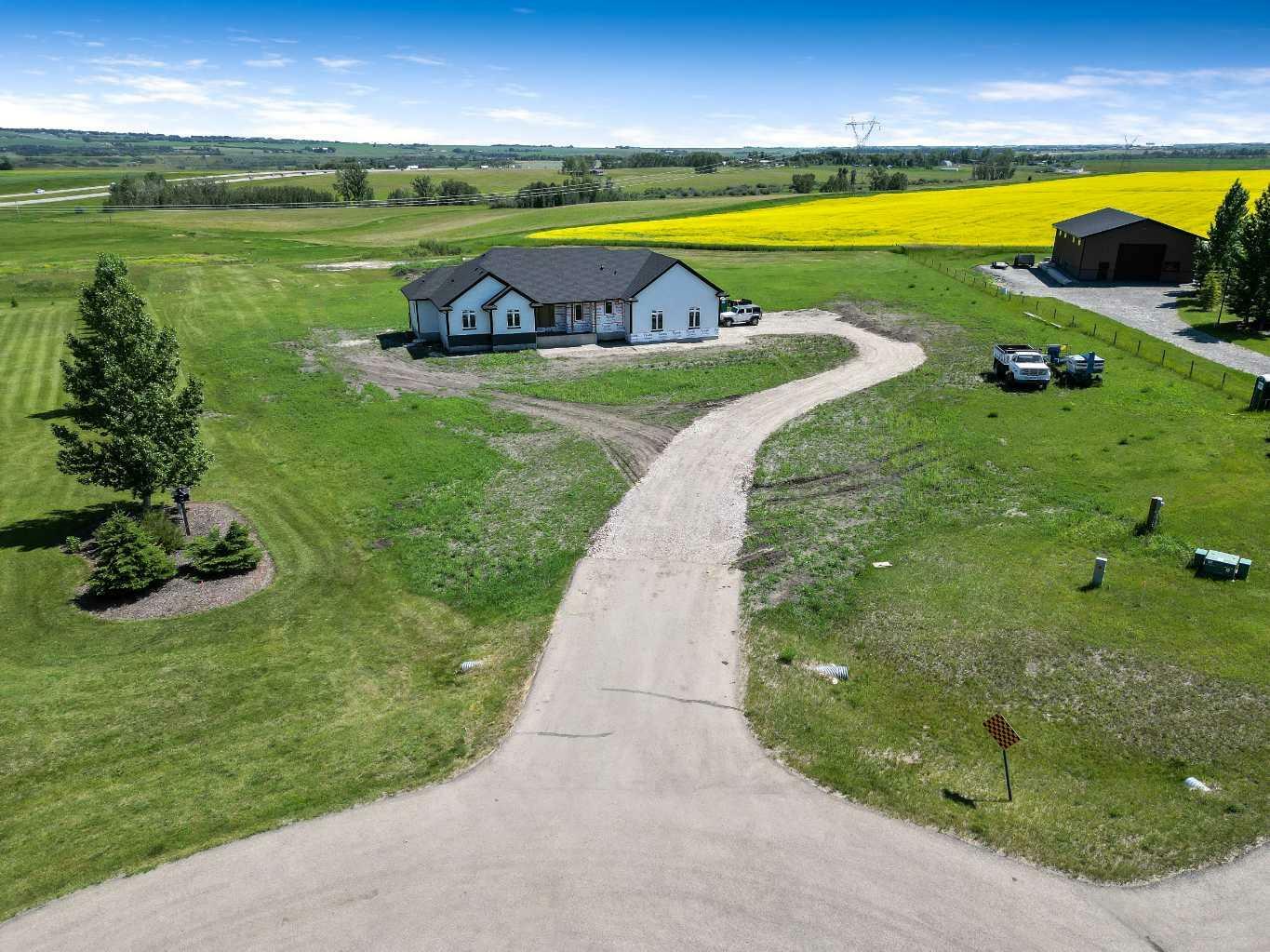 Property Photo: 349062 Tamarack Drive E AB T1S 5B8