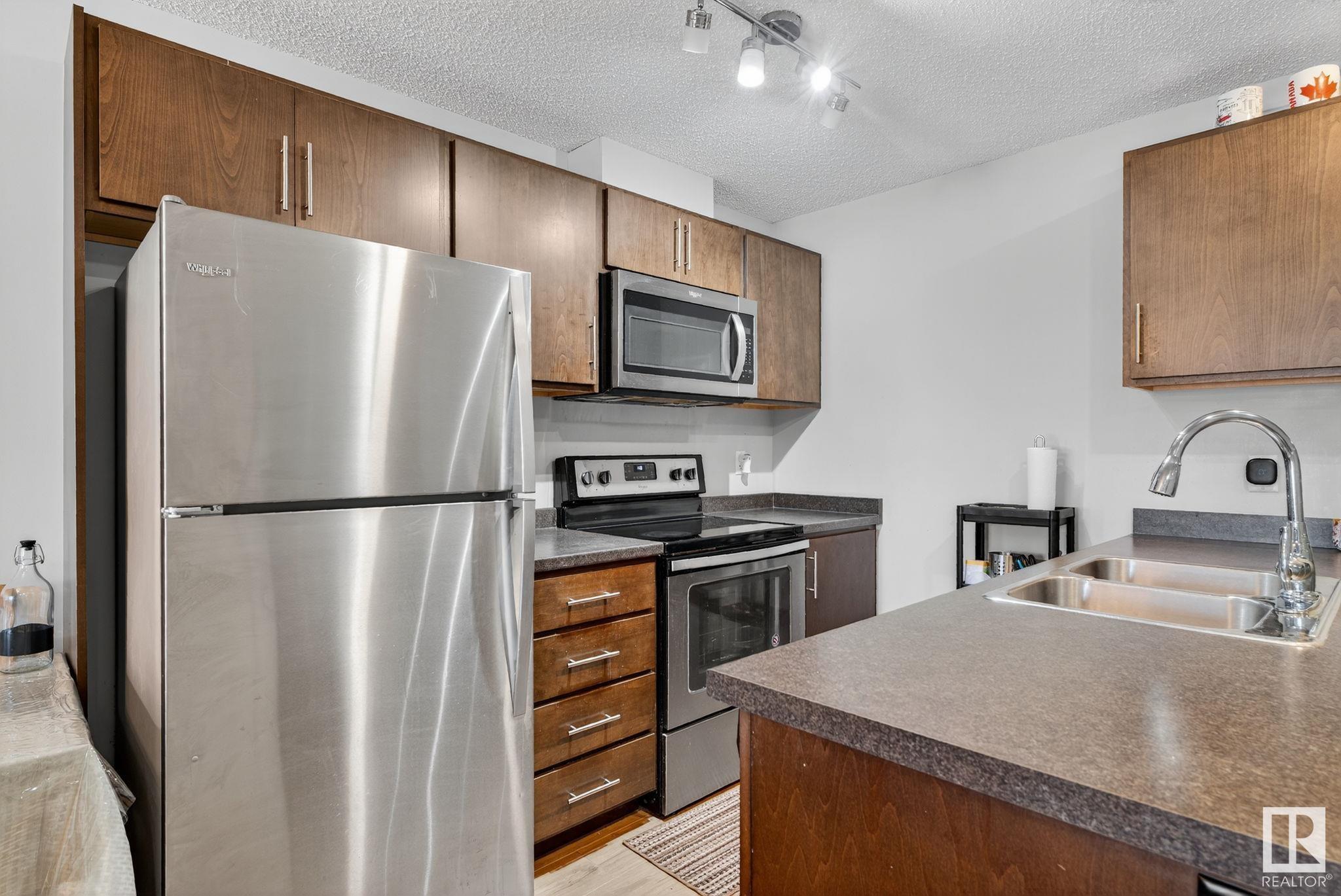 Property Photo:  5404 7 Avenue SW 110  AB T6K 2K4 