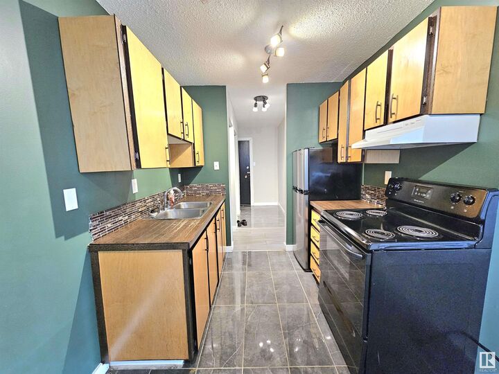 Property Photo:  12929 127 Street NW 101  AB T5L 1B1 