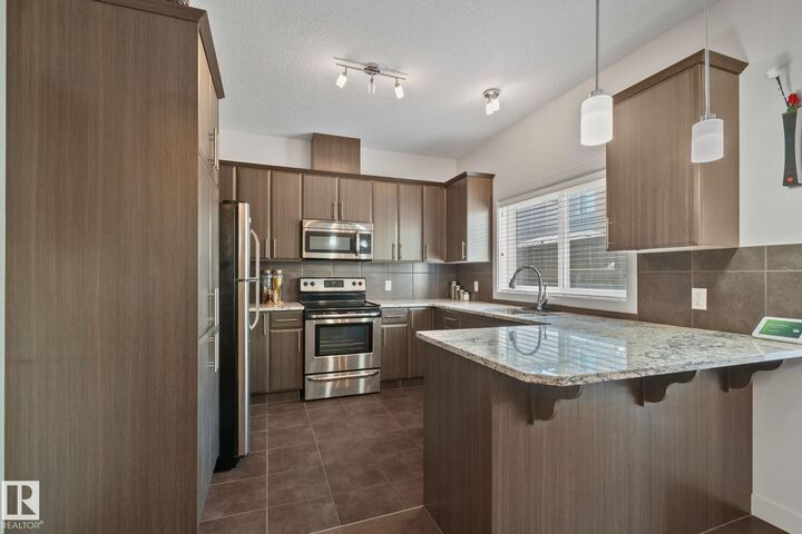 Property Photo:  450 McConachie Way NW 17  AB T5Y 0S8 