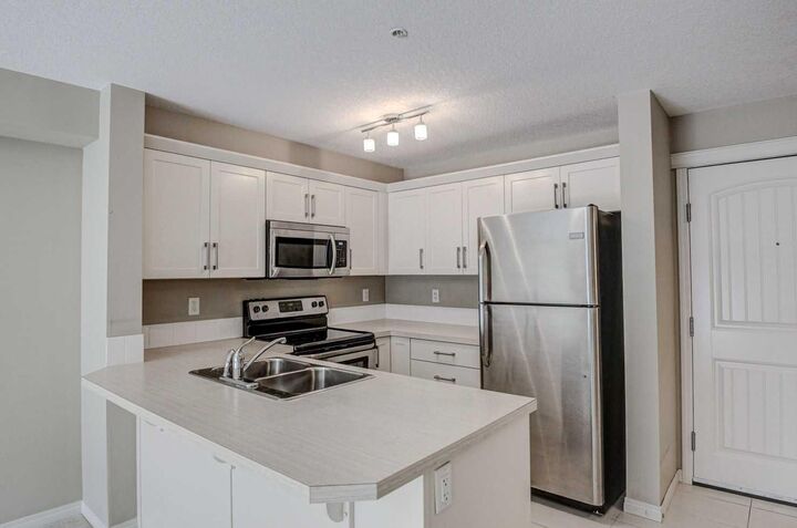 Property Photo:  130 Panatella Street NW 2217  AB T3K 0Y6 