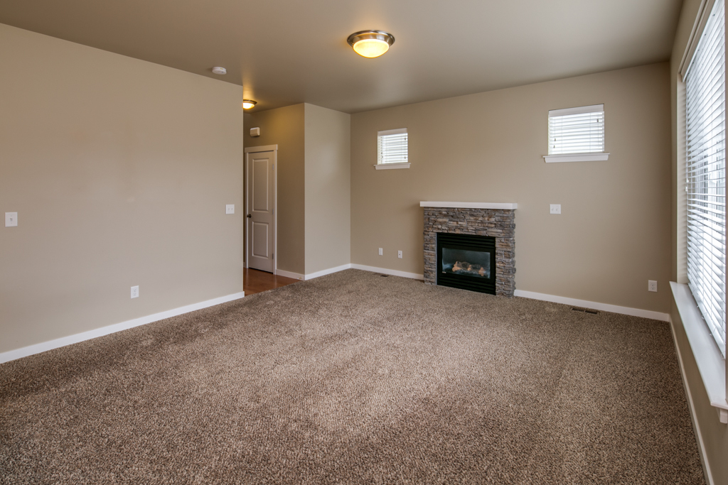 Property Photo: The living room is very spacious and has a natural gas fireplace with a flagstone surround, as well as large windows looking out. 4713 Hadley St  WA 98226 